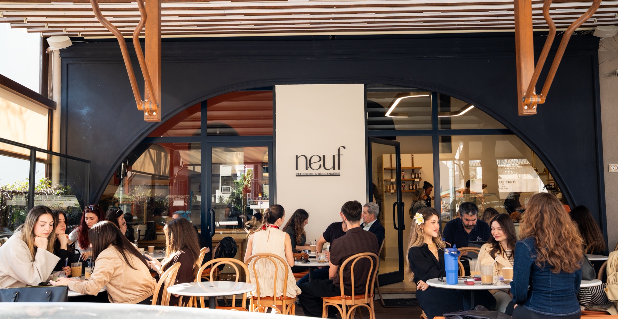Neuf'ün Bostanlı'daki cephesi, kemerli vitrin ve dolu masalar